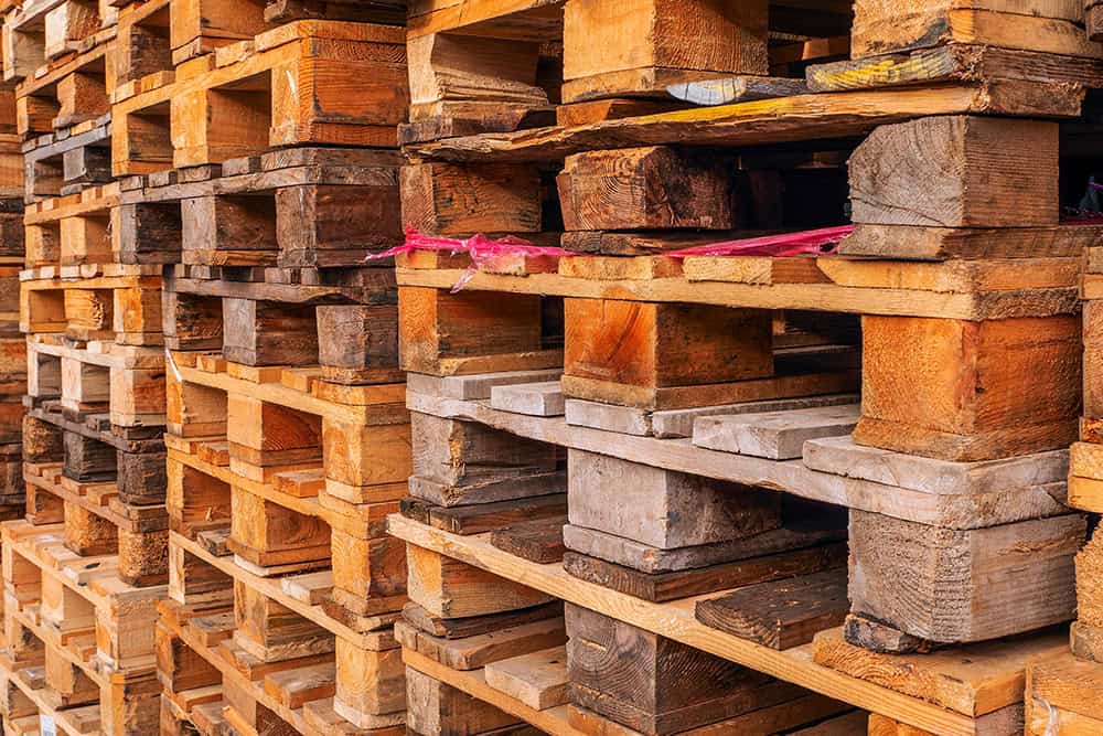 A large pile of wooden pallets. | Unlimited Solutions