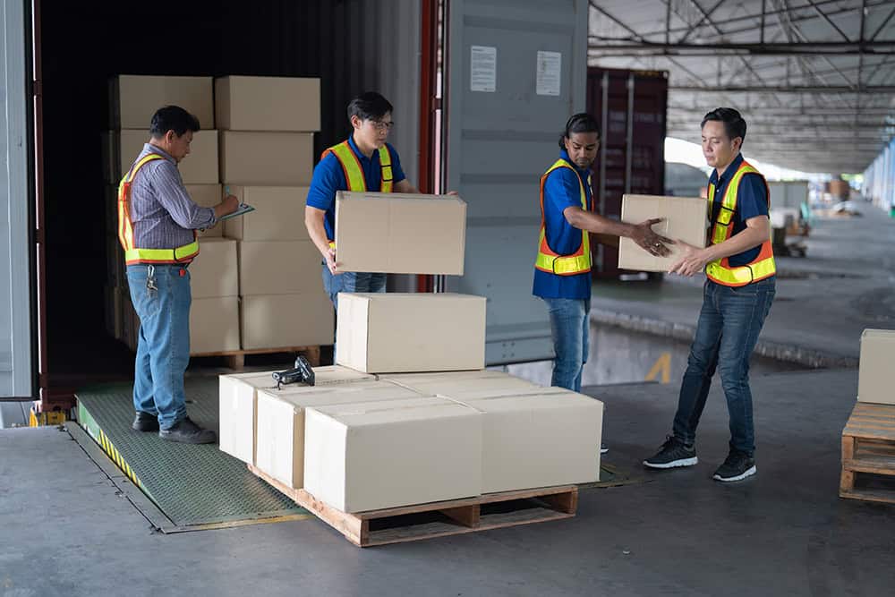 Workers unloading boxes from a truck. | Unlimited Solutions