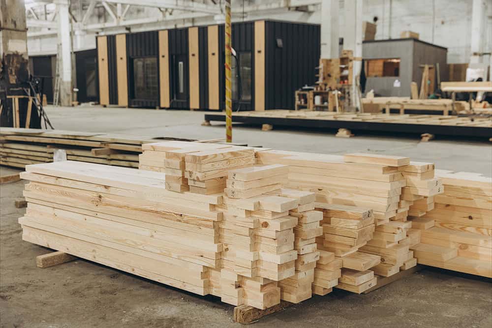 A large pile of wood in a warehouse. | Unlimited Solutions
